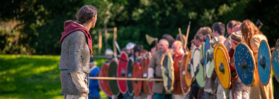 The Viking chief gazes over his battleline as it advances towards the enemy, banging thier shield with their weapons and yelling their war cries. Shields are round in shape and painted with bright colours. Warriors hold spears, swords, axes and long knives. Some where chailmail to protect them in the coming battle.